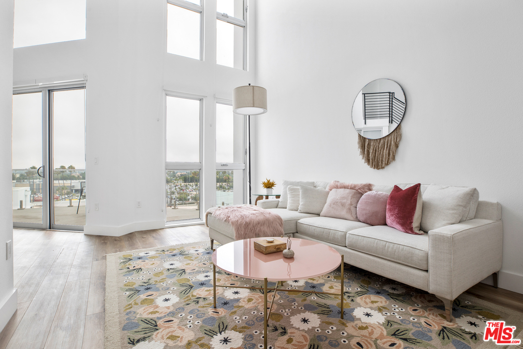 13448 Beach Avenue, Unit PH7314 Marina del Rey, CA 90292 - Photo 1 of 22 a living room with furniture and a large window