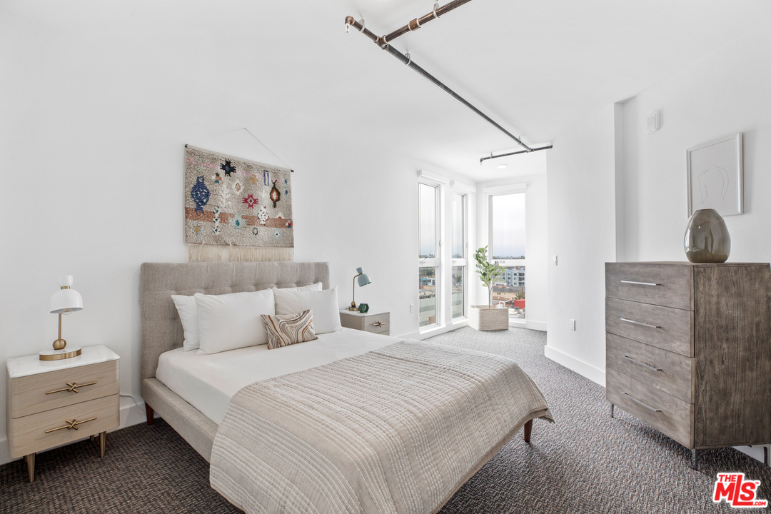 13448 Beach Avenue, Unit PH7314 Marina del Rey, CA 90292 - Photo 13 of 22 a bedroom with a bed and a painting on the wall