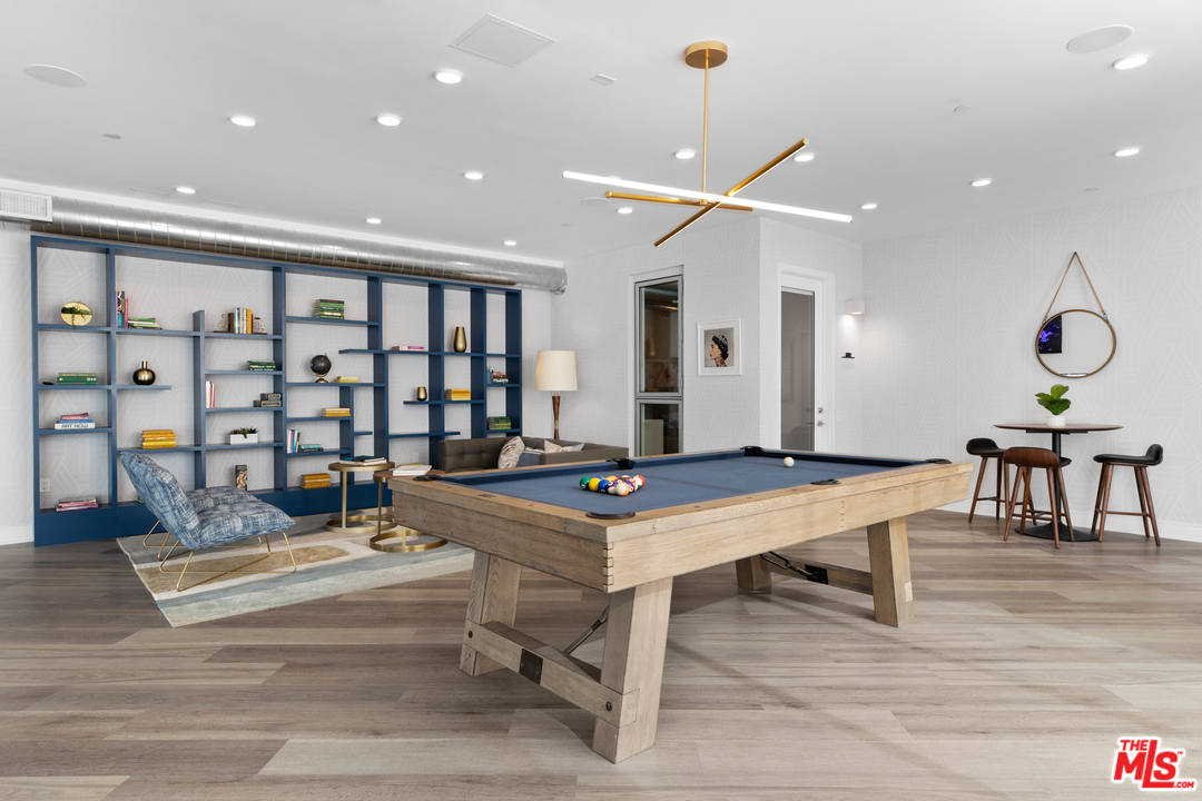 13448 Beach Avenue, Unit PH7314 Marina del Rey, CA 90292 - Photo 19 of 22 a living room with furniture a table and a chandelier