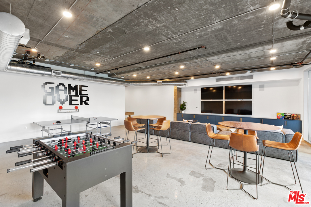 13448 Beach Avenue, Unit PH7314 Marina del Rey, CA 90292 - Photo 20 of 22 a living room with lots of furniture and a flat screen tv