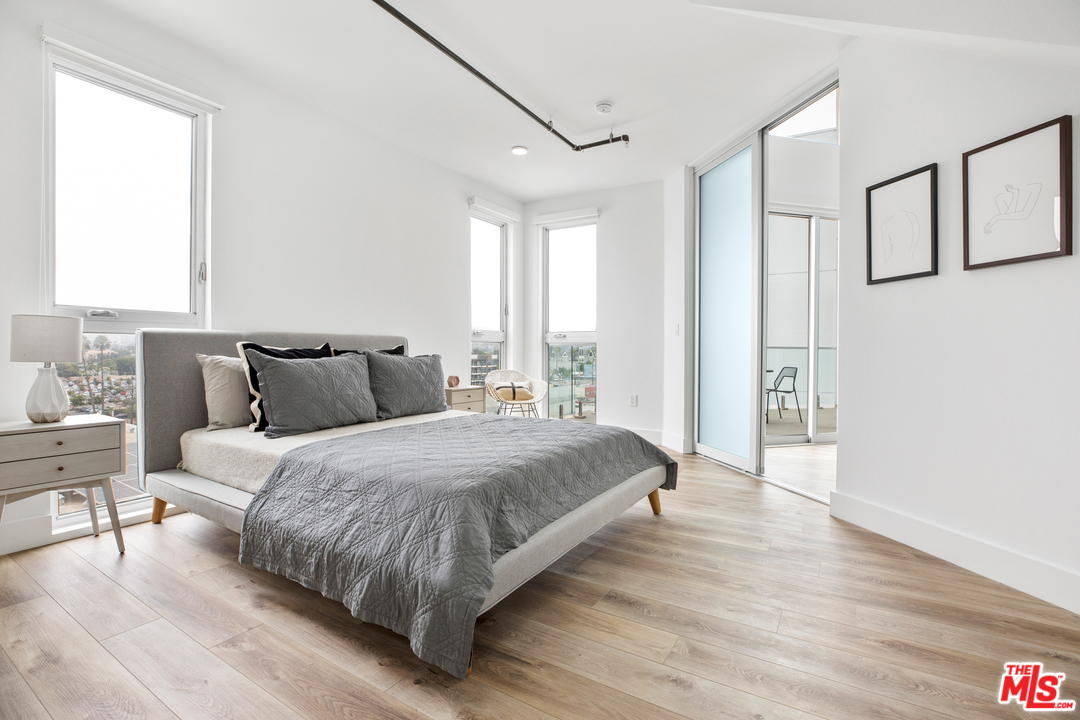 13448 Beach Avenue, Unit PH7314 Marina del Rey, CA 90292 - Photo 10 of 22 a spacious bedroom with a bed and a table