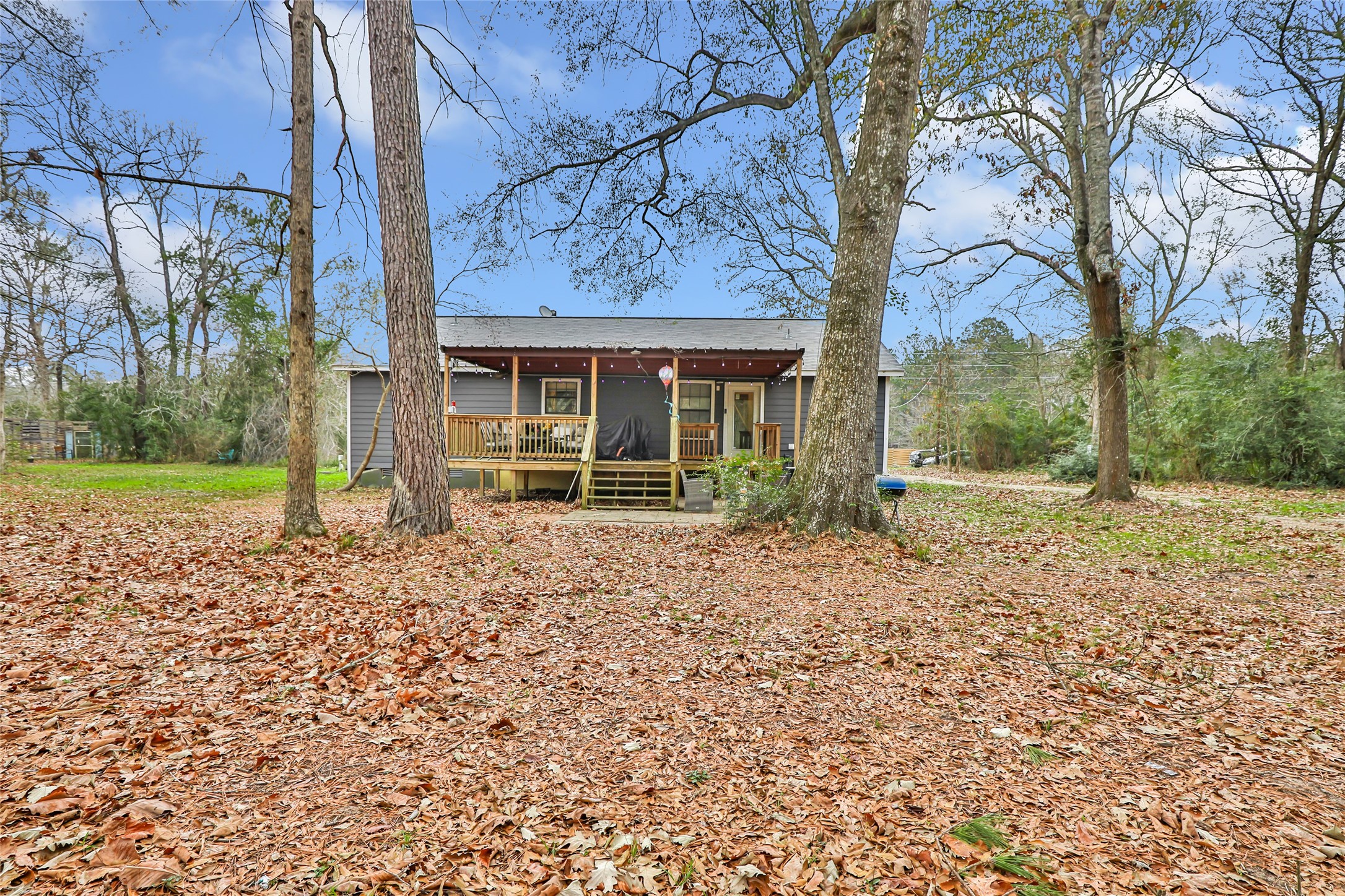 9660 Fostoria Road Cleveland, TX 77328 - Photo 11 of 31 a view of a house with a yard and large tree