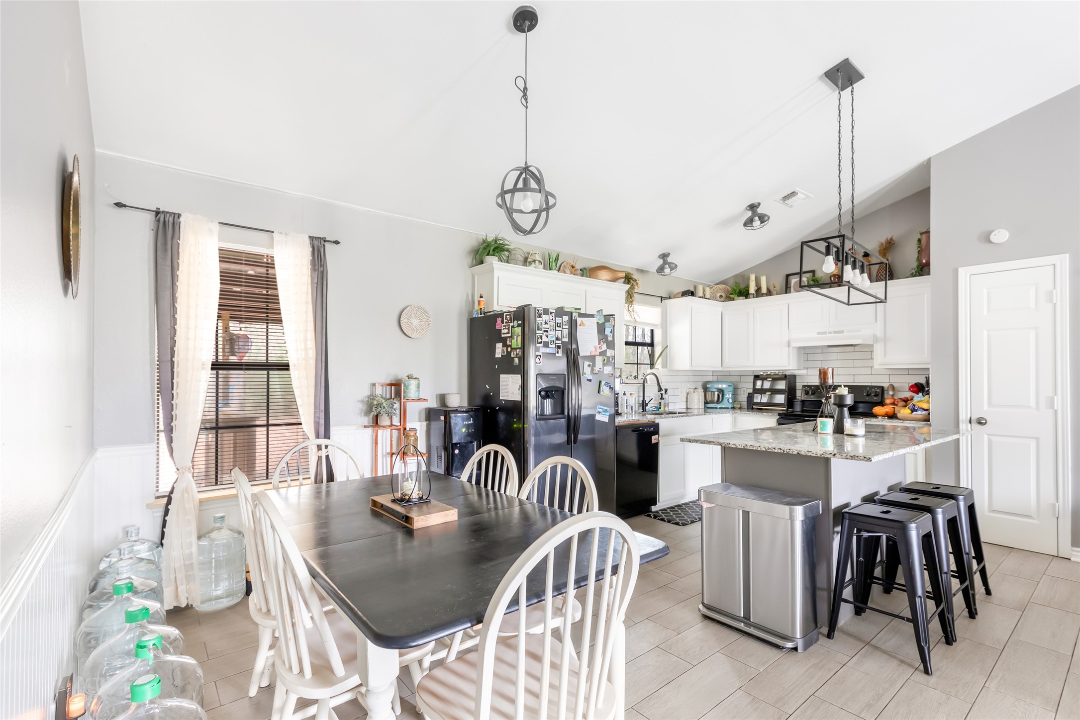 9660 Fostoria Road Cleveland, TX 77328 - Photo 20 of 31 a very nice looking dining room with kitchen island furniture a large window and stainless steel appliances