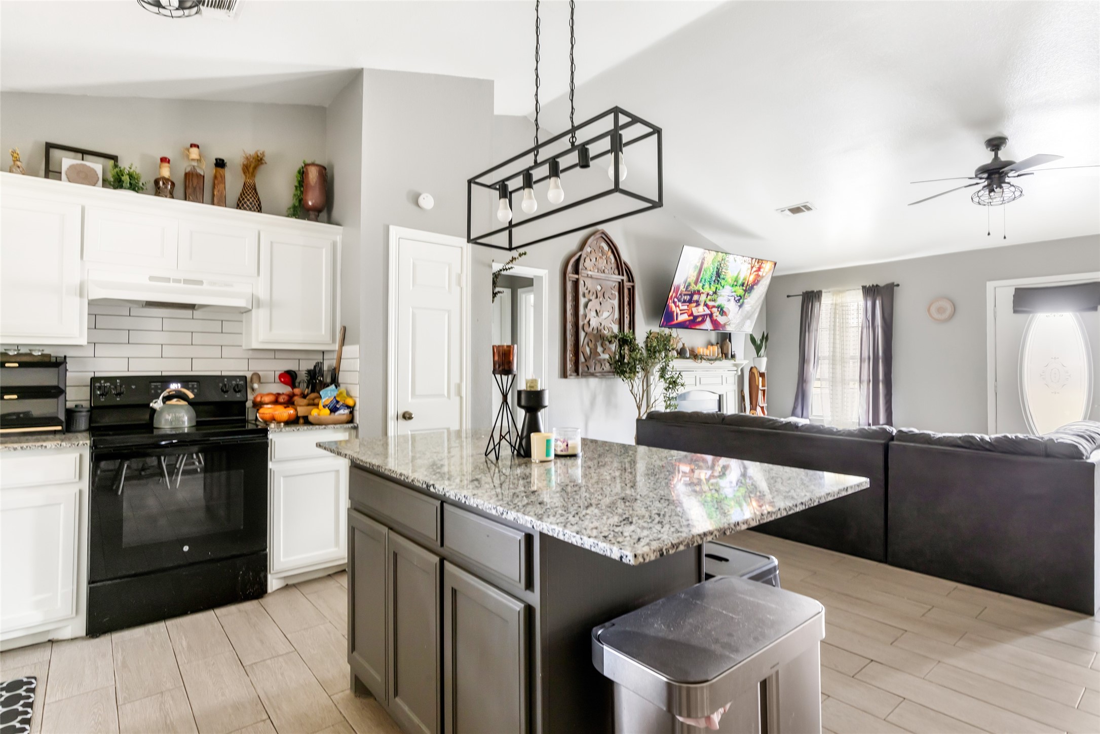 9660 Fostoria Road Cleveland, TX 77328 - Photo 22 of 31 a kitchen with kitchen island granite countertop a sink appliances and cabinets