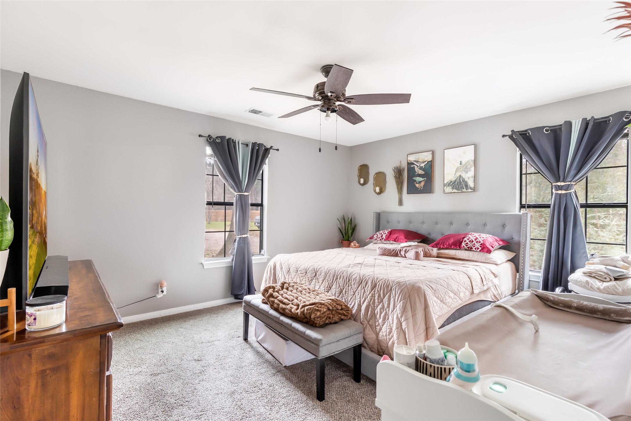9660 Fostoria Road Cleveland, TX 77328 - Photo 26 of 31 a bedroom with a bed and a chandelier