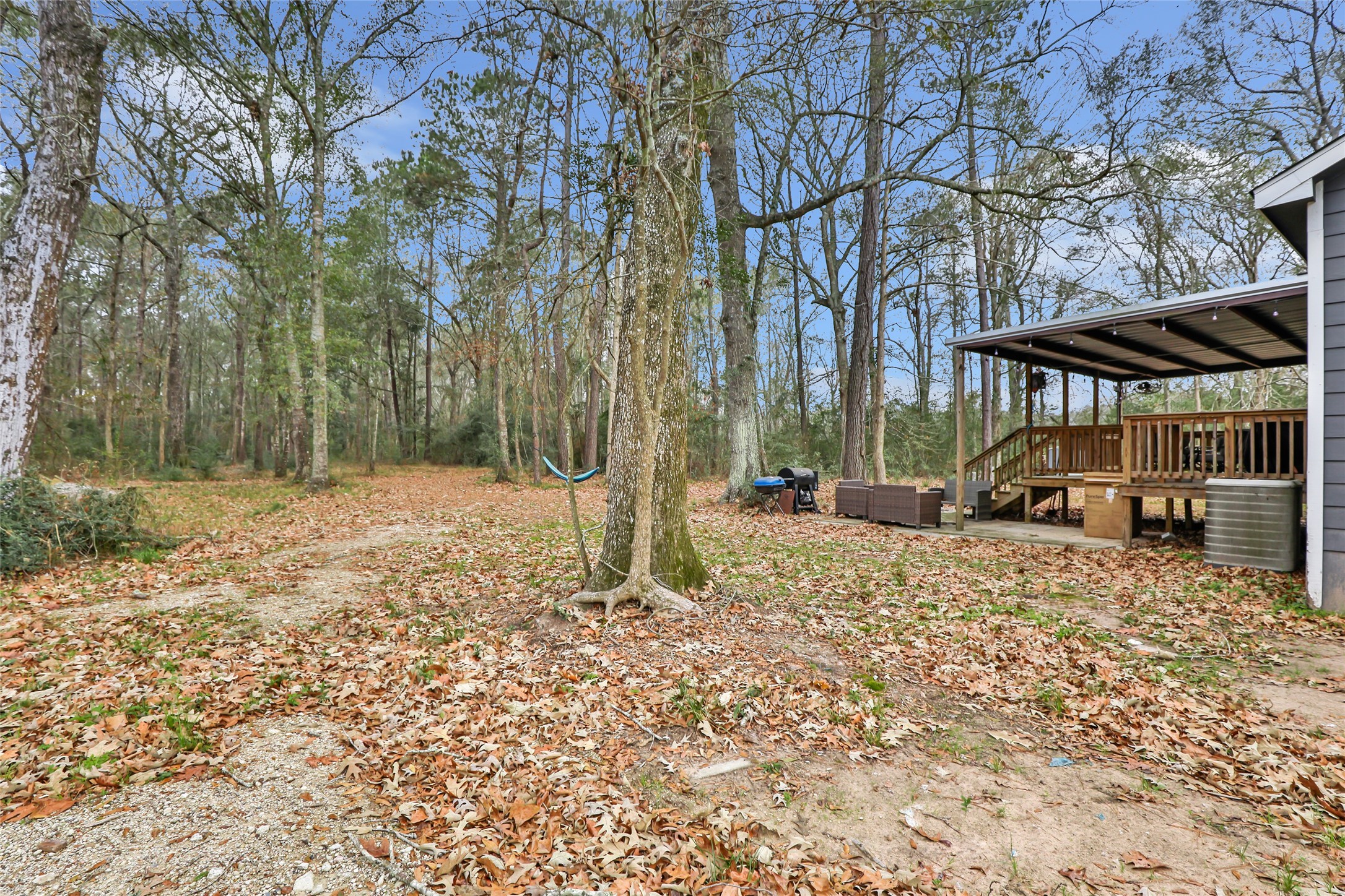 9660 Fostoria Road Cleveland, TX 77328 - Photo 9 of 31 a house with trees in front of it