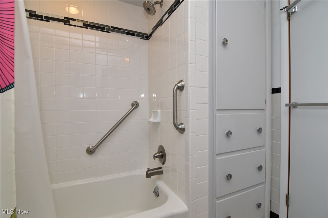 2071 Wyndham Road Akron, OH 44313 - Photo 27 of 42 Bathroom with shower / bath combination with curtain and built-in cabinetry.