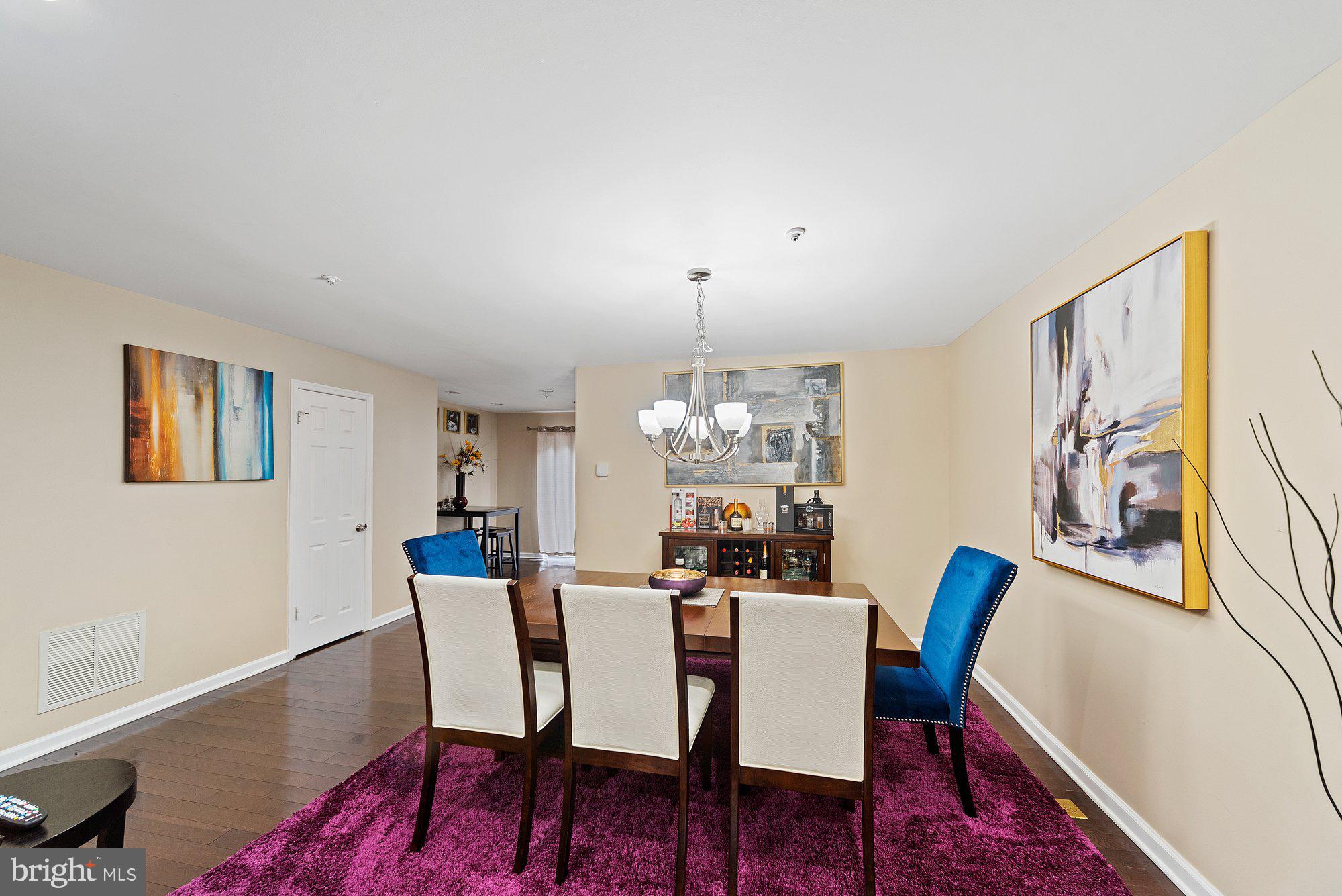 3535 Corn Stream Road Randallstown, MD 21133 - Photo 4 of 25 a view of a dining room with furniture wooden floor and a chandelier