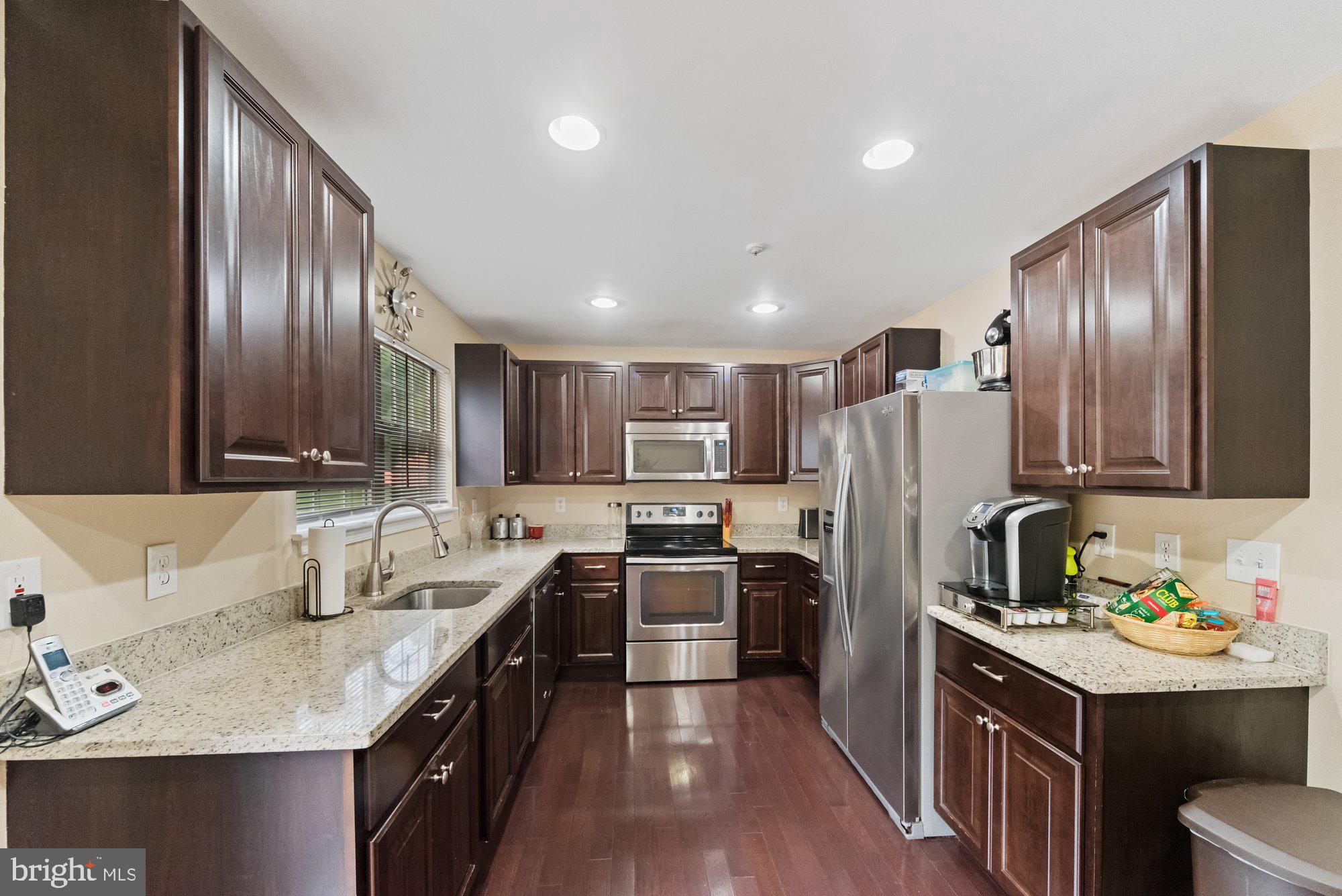 3535 Corn Stream Road Randallstown, MD 21133 - Photo 8 of 25 a kitchen with a sink stove and refrigerator