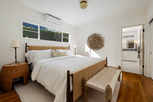 a bedroom with a bed and a table