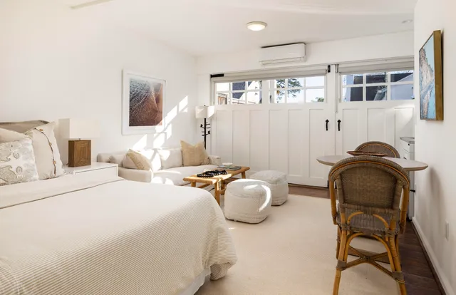 a bedroom with furniture and balcony