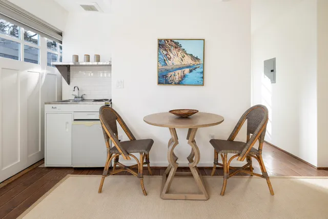 a view of a dining room with furniture and a chandelier