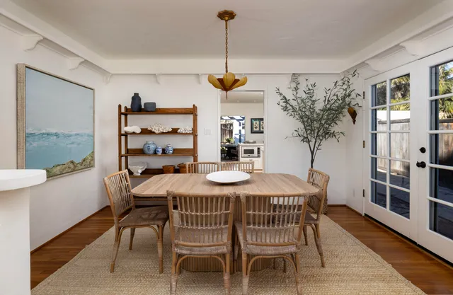 a dining room with furniture window and wooden floor