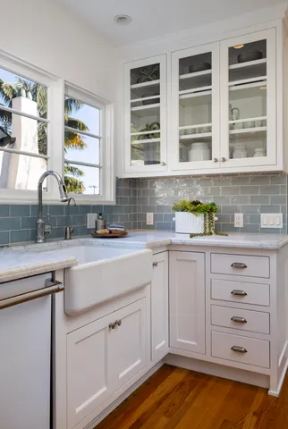 a kitchen with stainless steel appliances cabinets and a window
