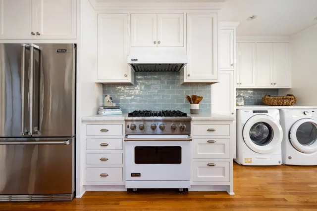 a kitchen with a stove and white cabinets