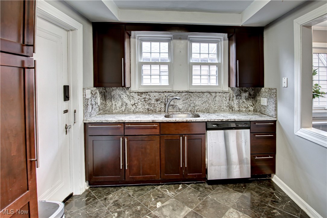 17800 Winslow Road Beachwood, OH 44122 - Photo 7 of 31 Kitchen featuring decorative backsplash, light stone counters, stainless steel dishwasher, and sink