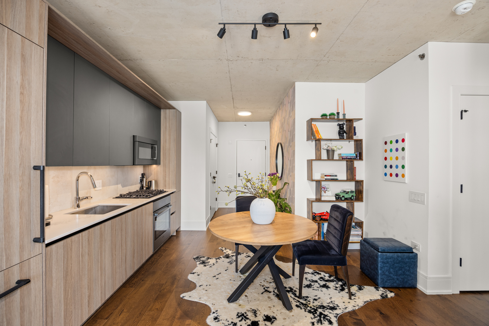 Undisclosed Address Chicago, IL 60607 - Photo 11 of 44 a kitchen with a dining table chairs and white appliances