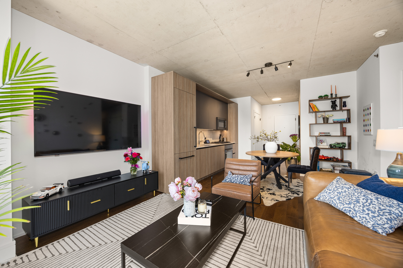 Undisclosed Address Chicago, IL 60607 - Photo 12 of 44 a living room with furniture and a flat screen tv