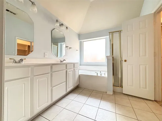 a bathroom with a sink a mirror and a bathtub