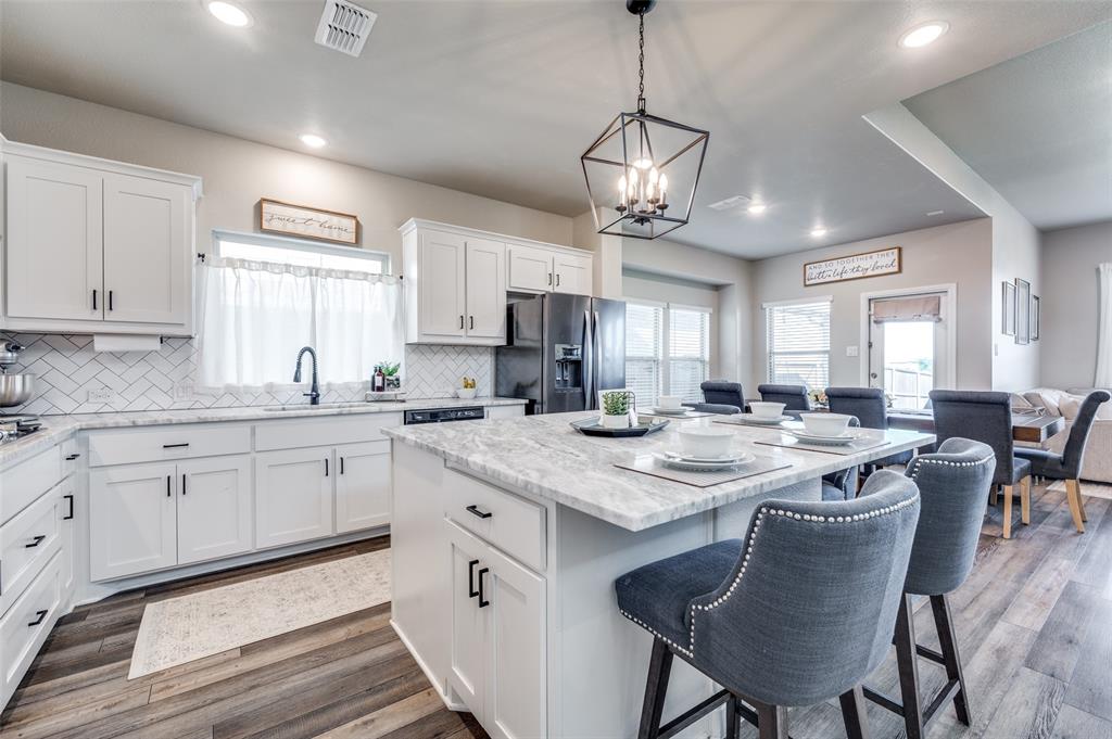 2113 Graham Road Anna, TX 75409 - Photo 11 of 38 a kitchen with cabinets table and chairs