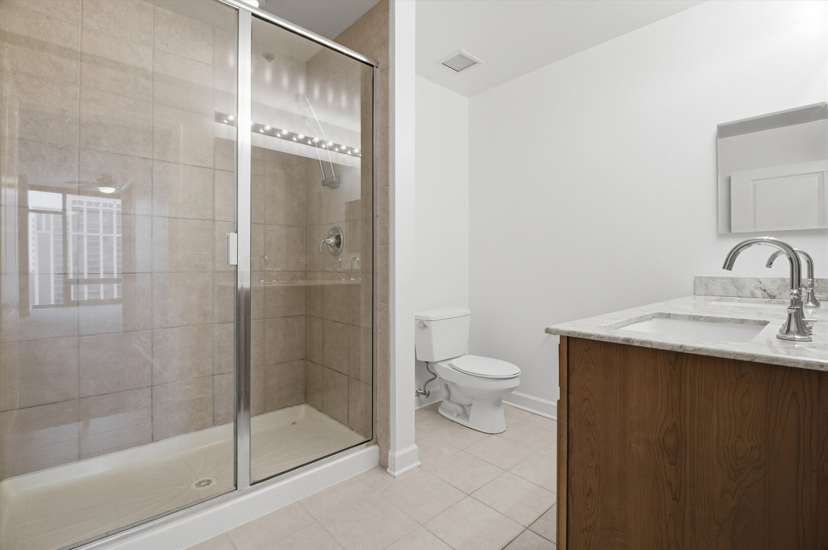 100 East 14th Street, Unit 1204 Chicago, IL 60605 - Photo 15 of 28 a bathroom with a granite countertop sink toilet and shower