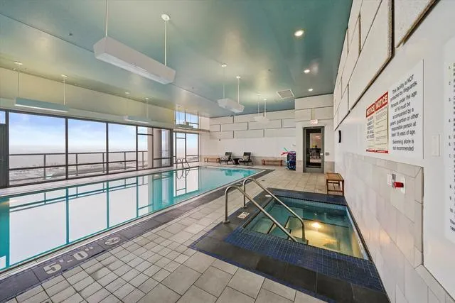 a kitchen with stainless steel appliances granite countertop a sink and a refrigerator