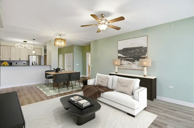 a living room with furniture and a dining table with wooden floor