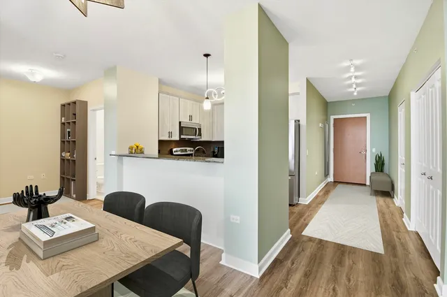 a view of a dining room with furniture and wooden floor
