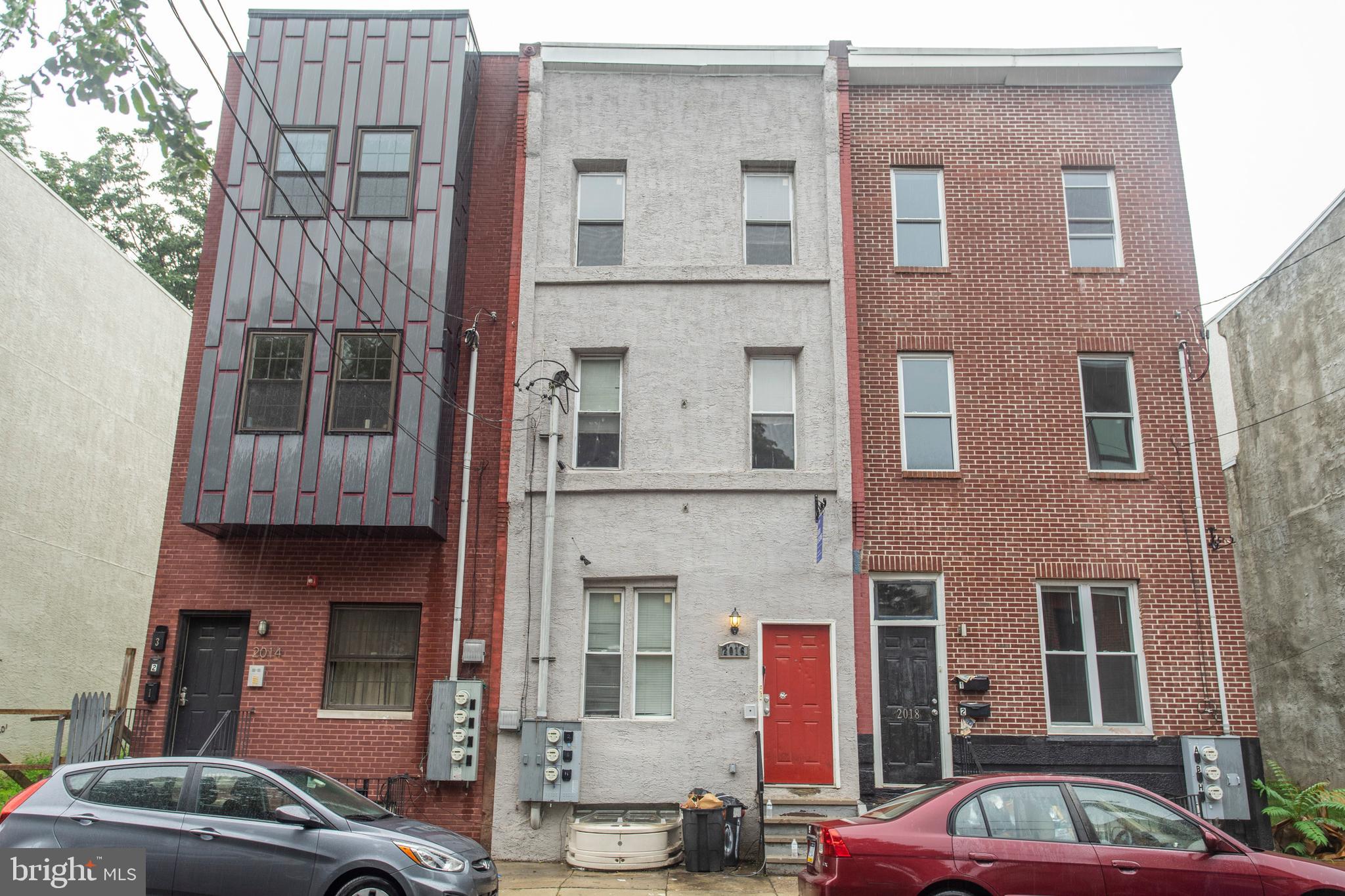2016 North 18th Street, Unit 2 Philadelphia, PA 19121 - Photo 2 of 23 a front view of a building with glass windows and a street