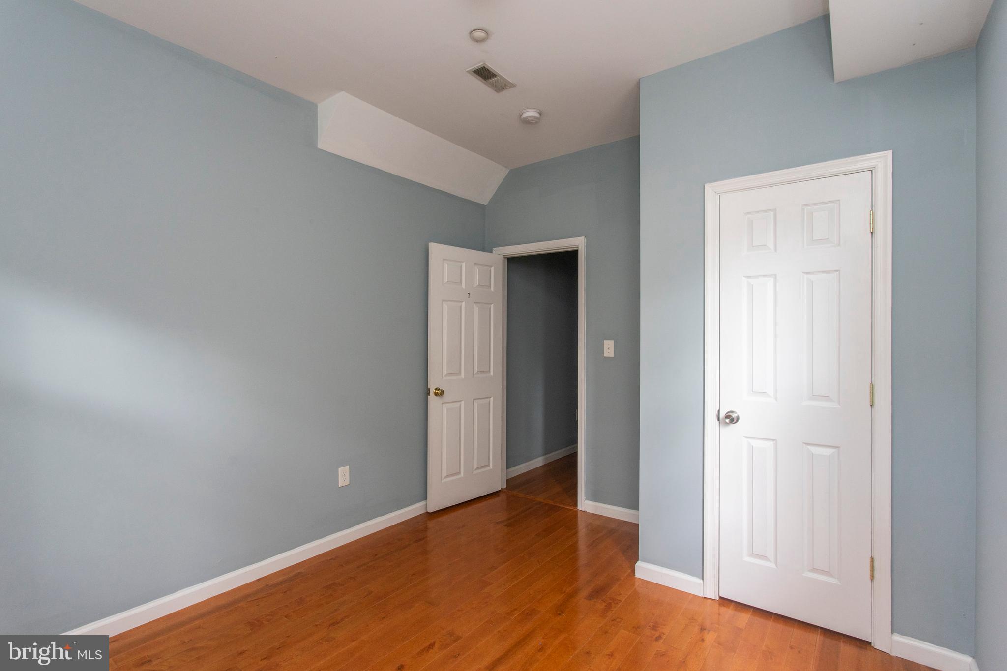 2016 North 18th Street, Unit 2 Philadelphia, PA 19121 - Photo 22 of 23 an empty room with wooden floor and closet