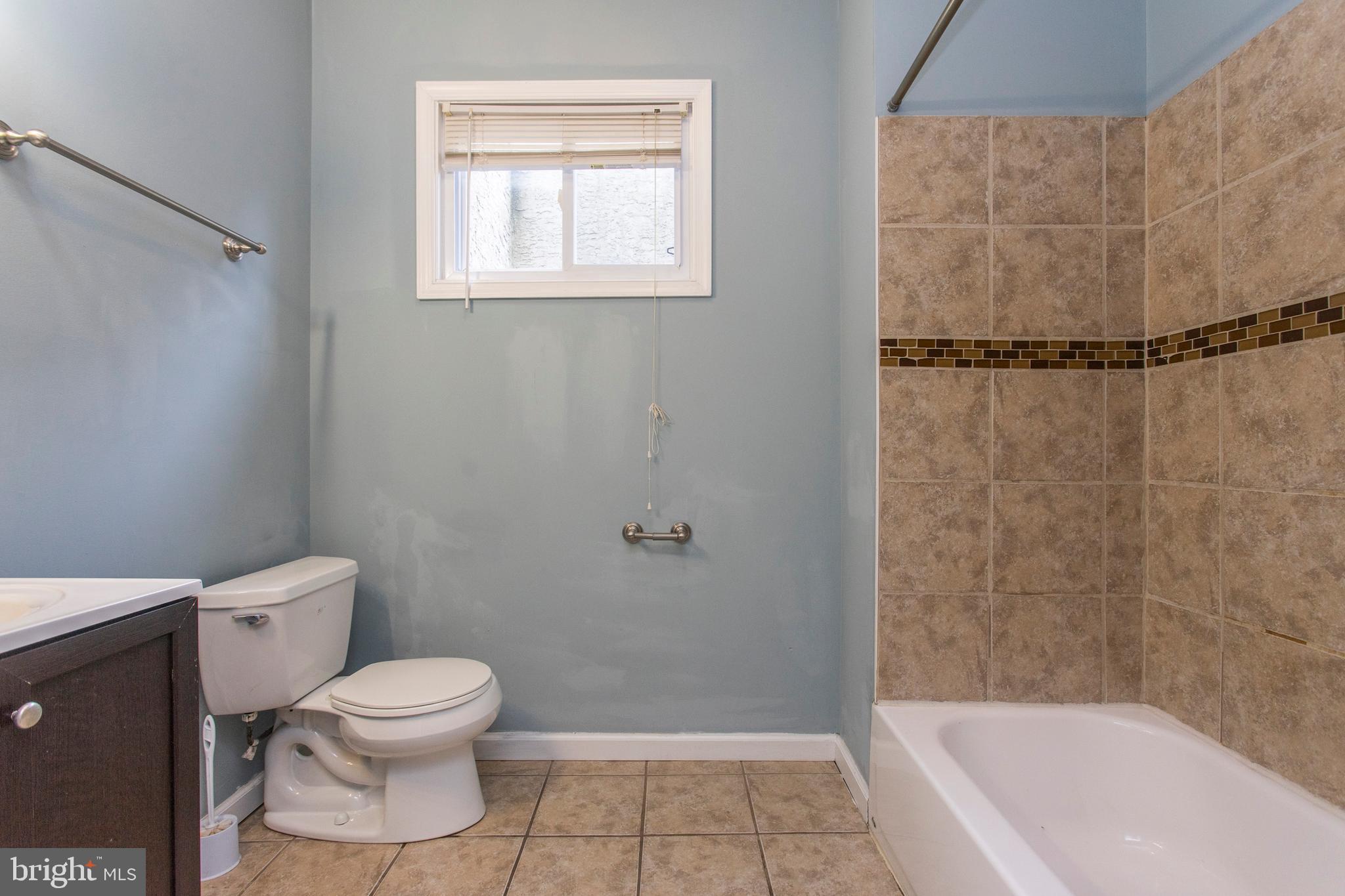 2016 North 18th Street, Unit 2 Philadelphia, PA 19121 - Photo 8 of 23 a white toilet sitting next to a bath tub and a shower