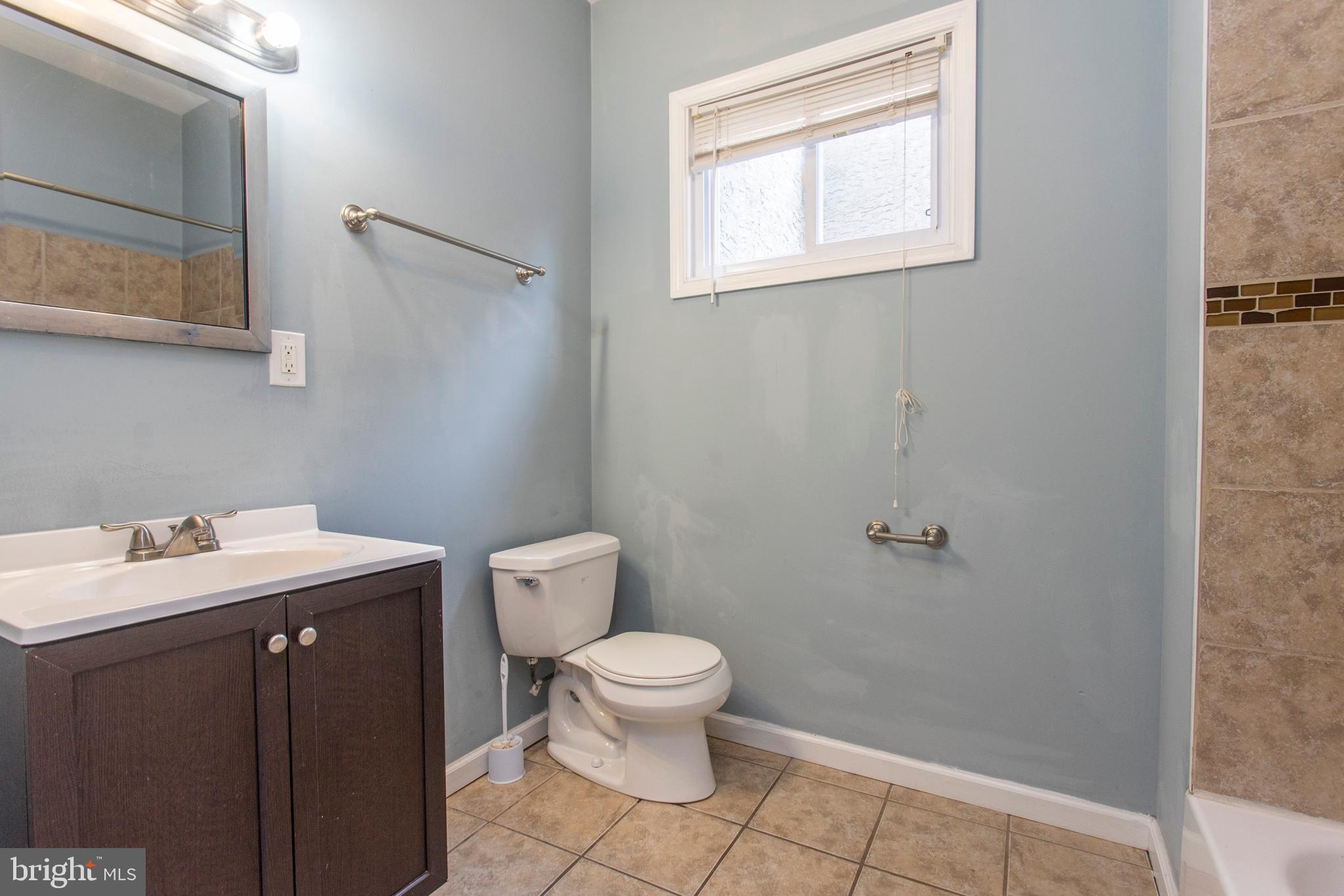 2016 North 18th Street, Unit 2 Philadelphia, PA 19121 - Photo 9 of 23 a bathroom with a sink a toilet and a mirror