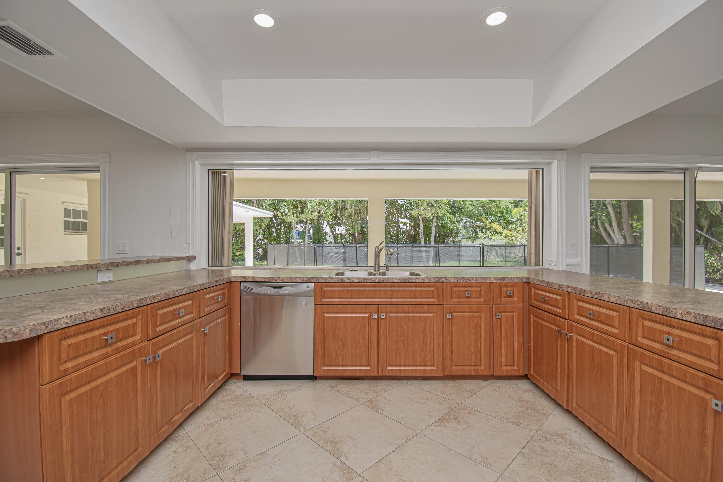 6749 South Grande Drive Boca Raton, FL 33433 - Photo 11 of 35 a large kitchen with granite countertop cabinets and a sink
