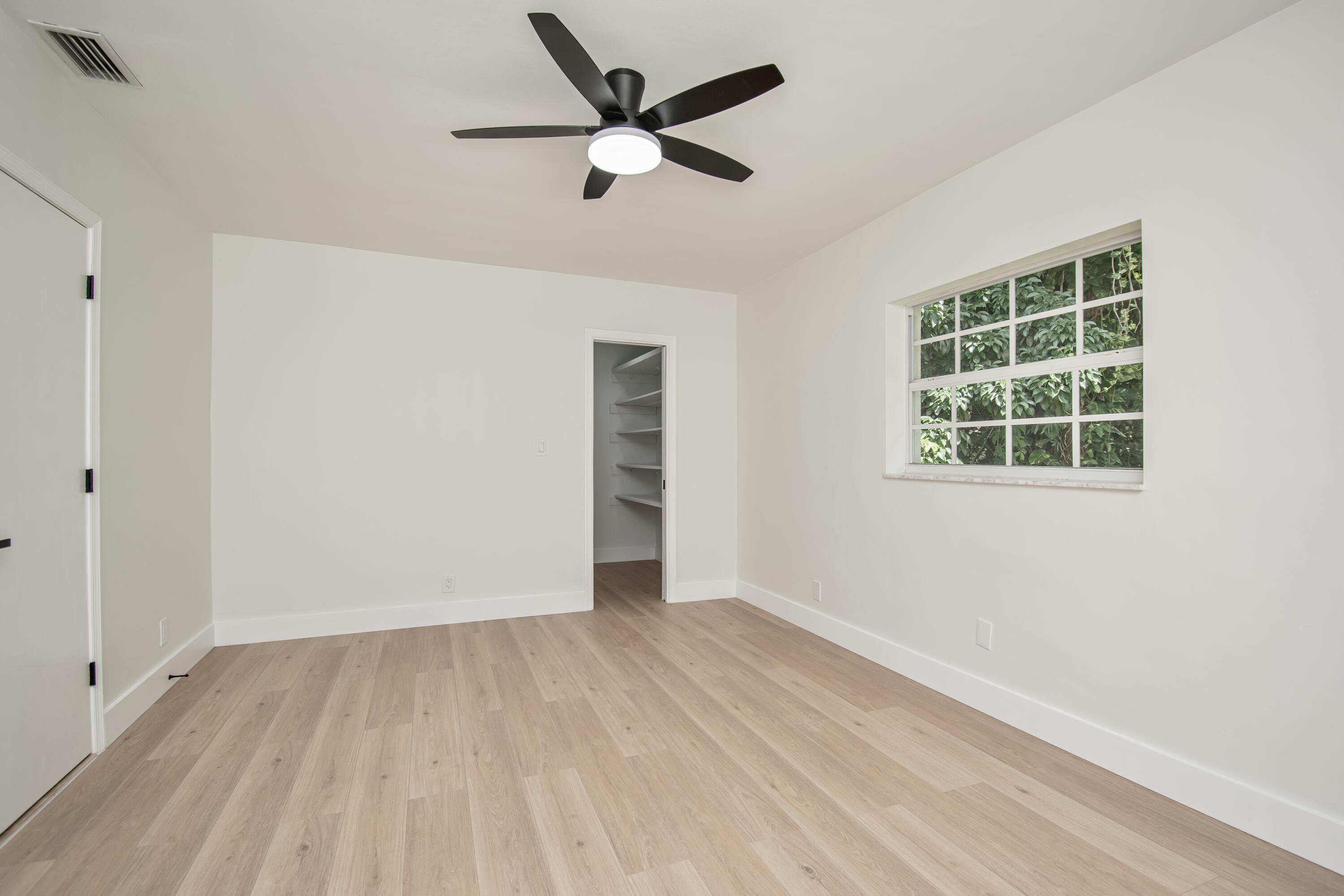 6749 South Grande Drive Boca Raton, FL 33433 - Photo 19 of 35 wooden floor in an empty room with a window