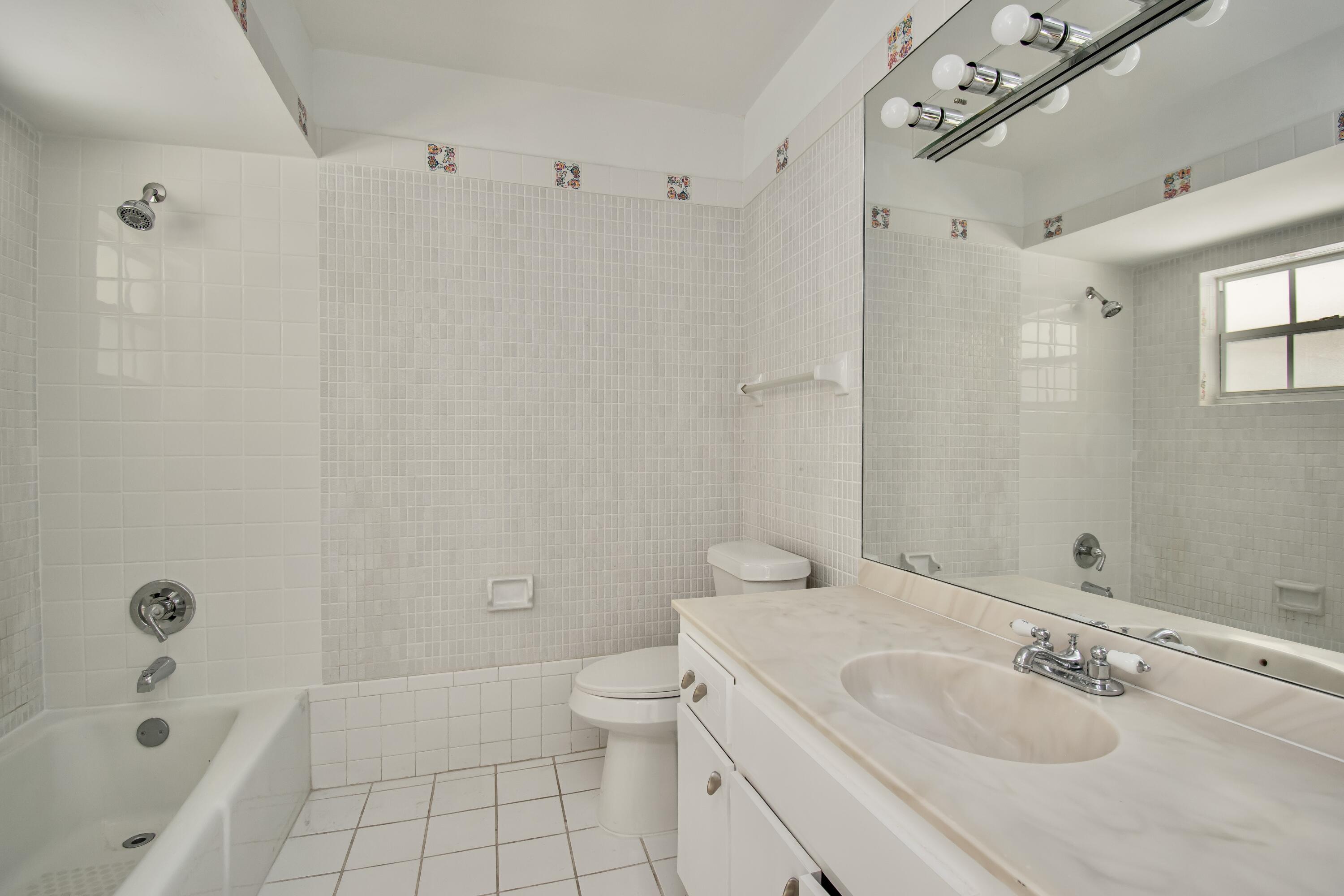 6749 South Grande Drive Boca Raton, FL 33433 - Photo 22 of 35 a bathroom with a sink a toilet and shower