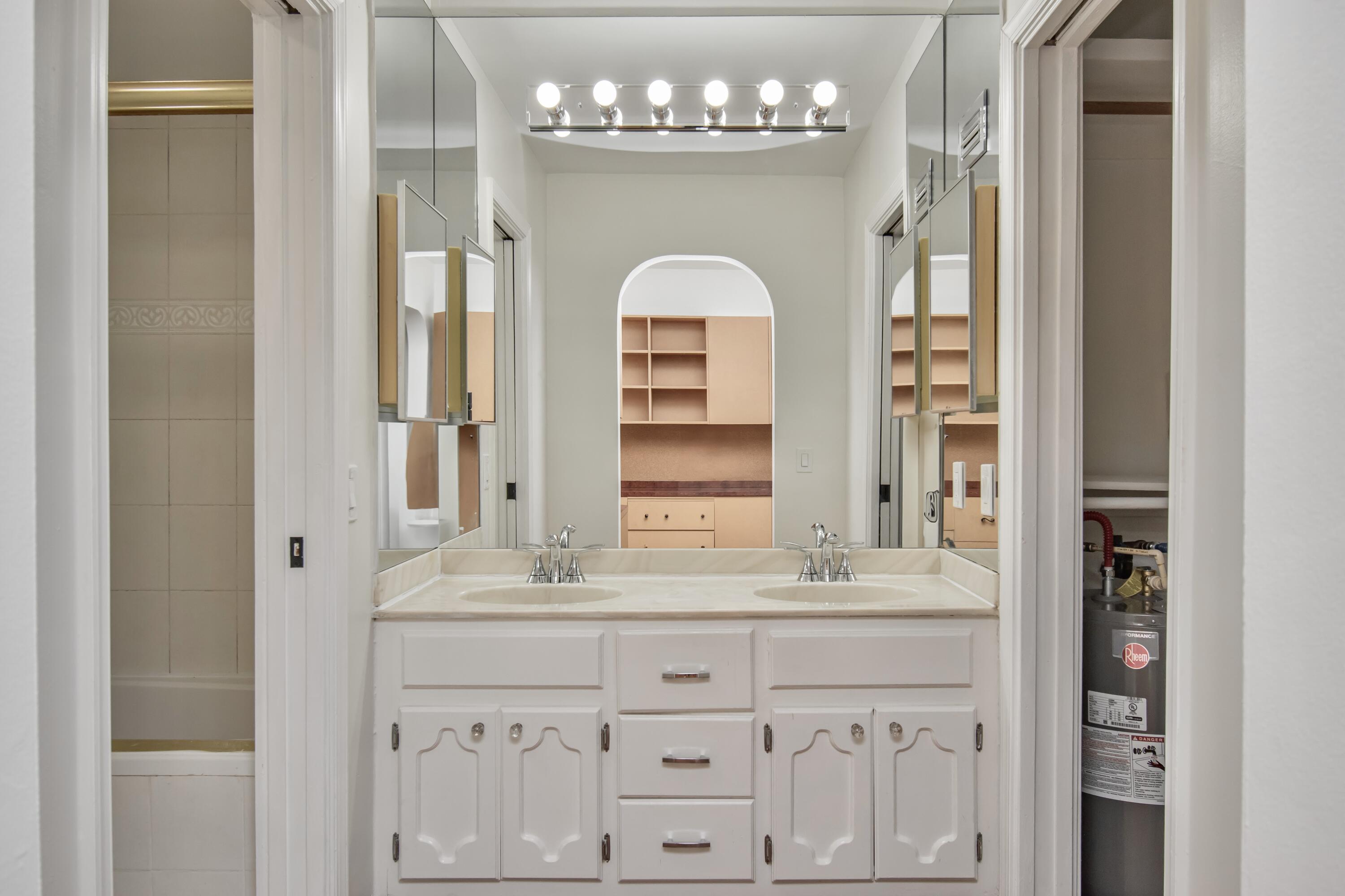 6749 South Grande Drive Boca Raton, FL 33433 - Photo 26 of 35 a bathroom with a double vanity sink and a mirror