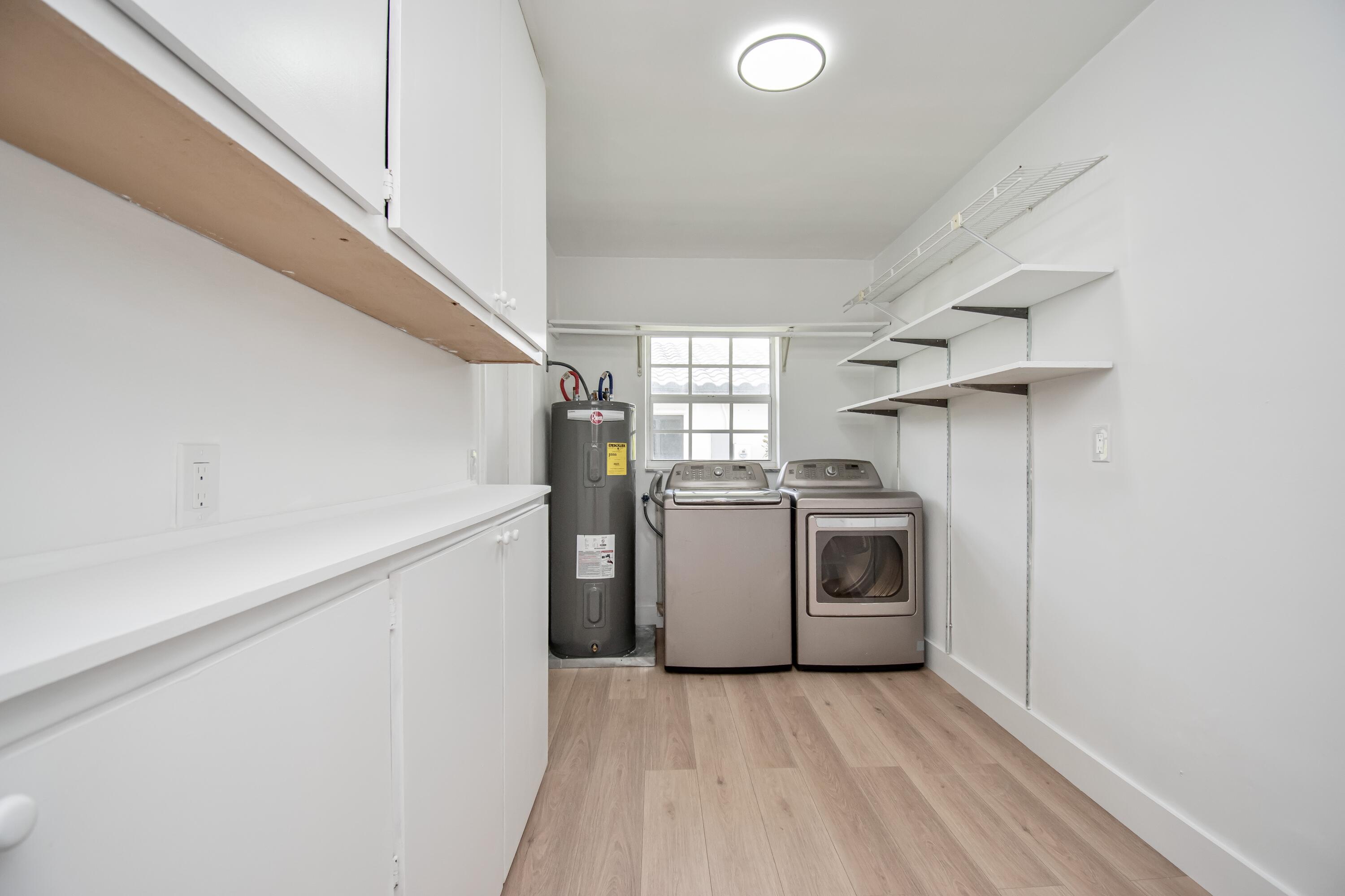 6749 South Grande Drive Boca Raton, FL 33433 - Photo 29 of 35 a utility room with sink dryer and washer