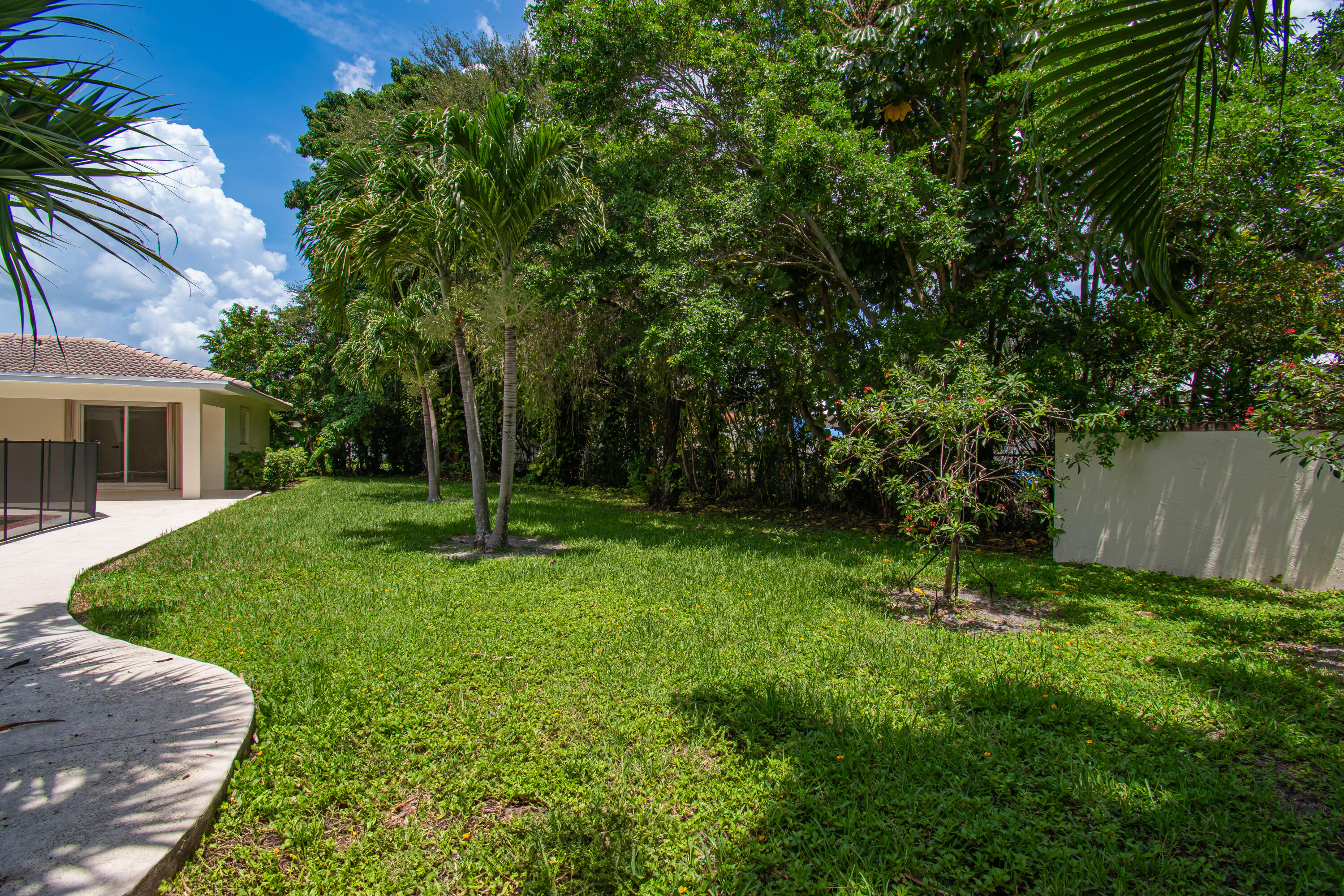 6749 South Grande Drive Boca Raton, FL 33433 - Photo 34 of 35 a view of backyard of house with green space