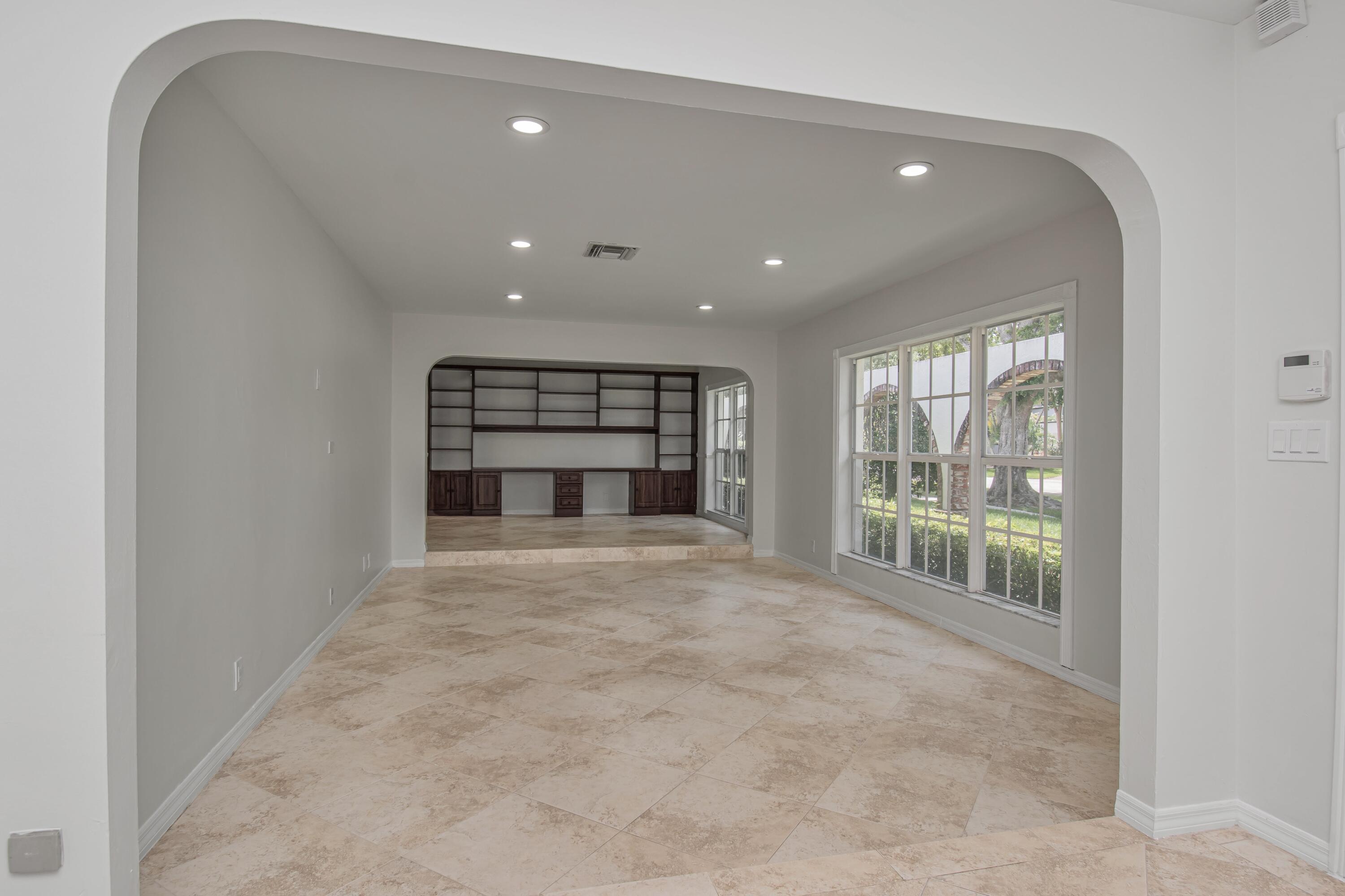 6749 South Grande Drive Boca Raton, FL 33433 - Photo 7 of 35 a big room with wooden floor fireplace and windows