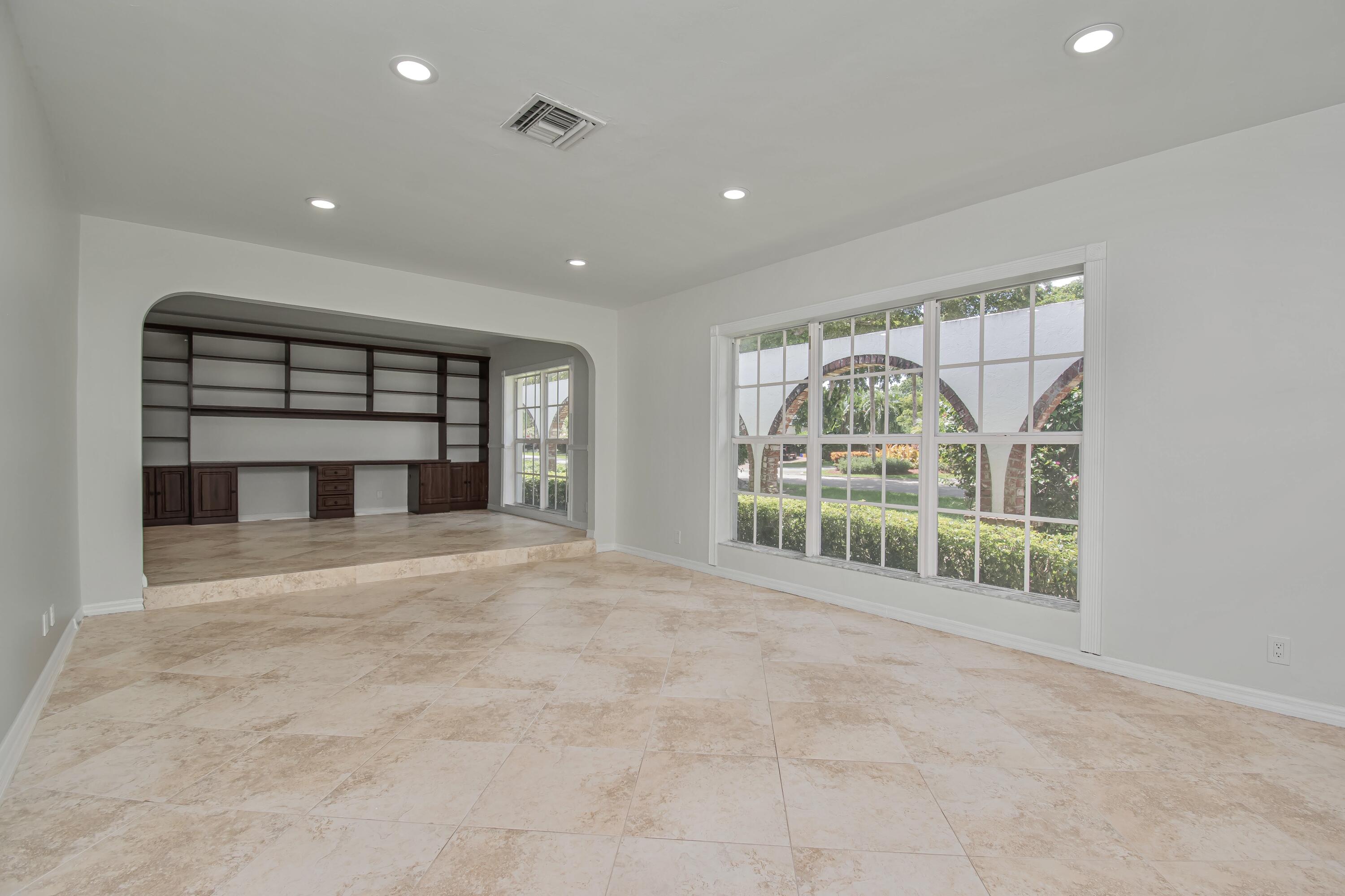6749 South Grande Drive Boca Raton, FL 33433 - Photo 8 of 35 a view of an empty room with a fireplace and a large window