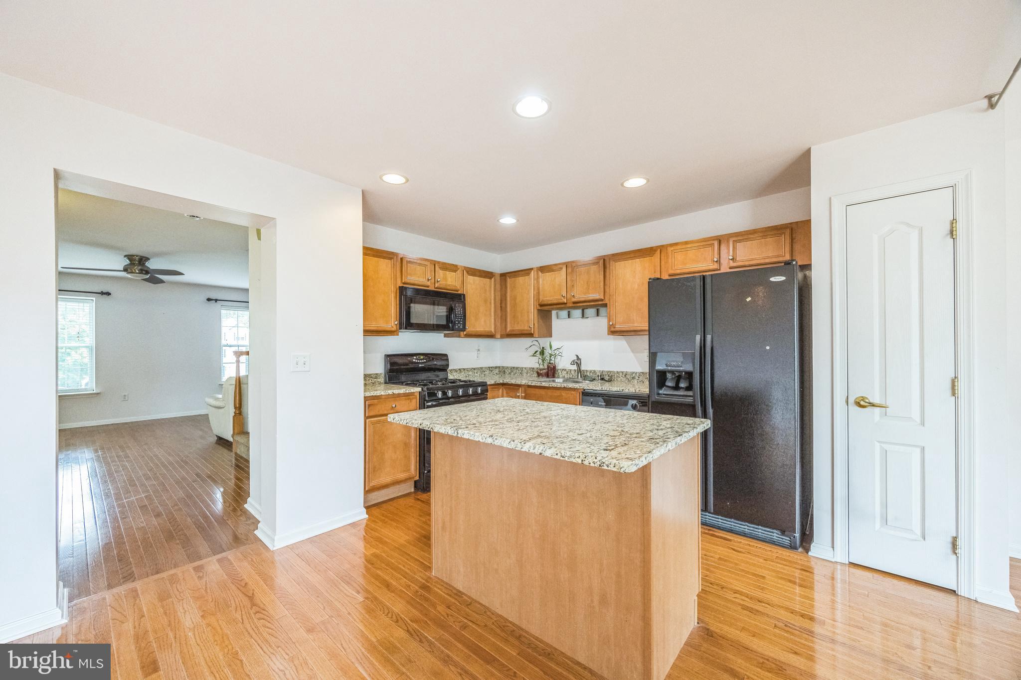 504 Nottingham Place Riverside, NJ 08075 - Photo 17 of 30 a kitchen with stainless steel appliances granite countertop a refrigerator a sink dishwasher a stove and a dining table with wooden floor