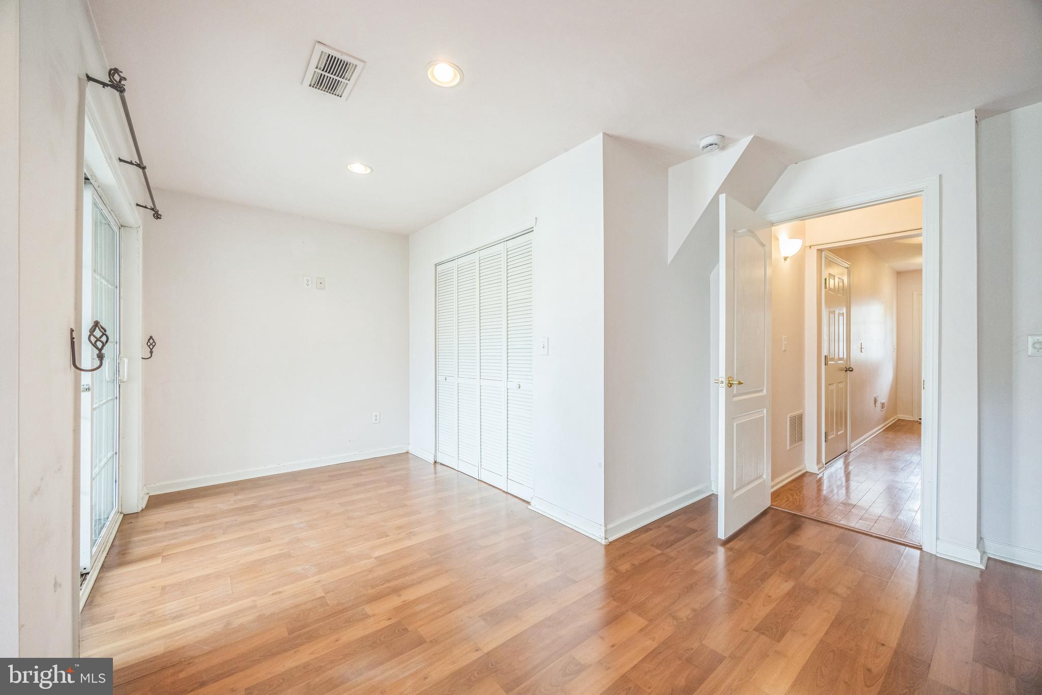 504 Nottingham Place Riverside, NJ 08075 - Photo 10 of 30 an empty room with wooden floor and a bathroom