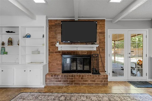 a living room with a fireplace and a flat screen tv