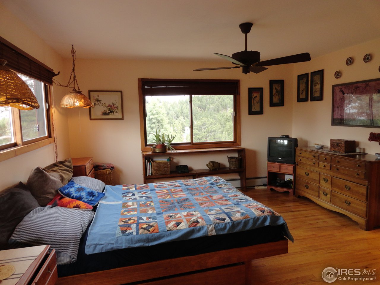 853 Deer Trail Road Boulder, CO 80302 - Photo 16 of 22 a bedroom with a bed and wooden floor