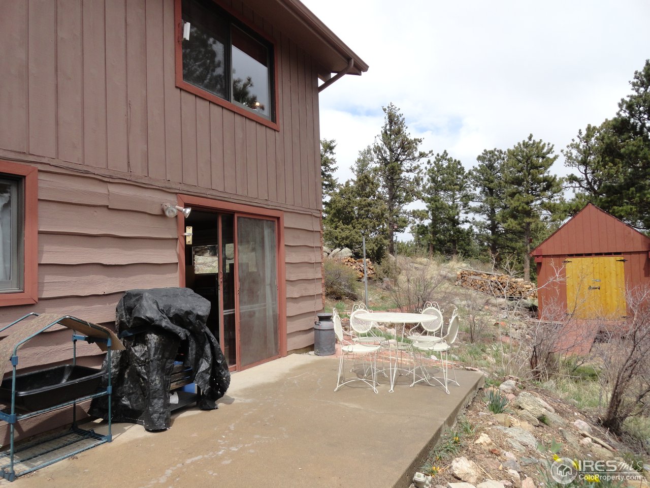 853 Deer Trail Road Boulder, CO 80302 - Photo 19 of 22 a view of a patio with table and chairs under an umbrella