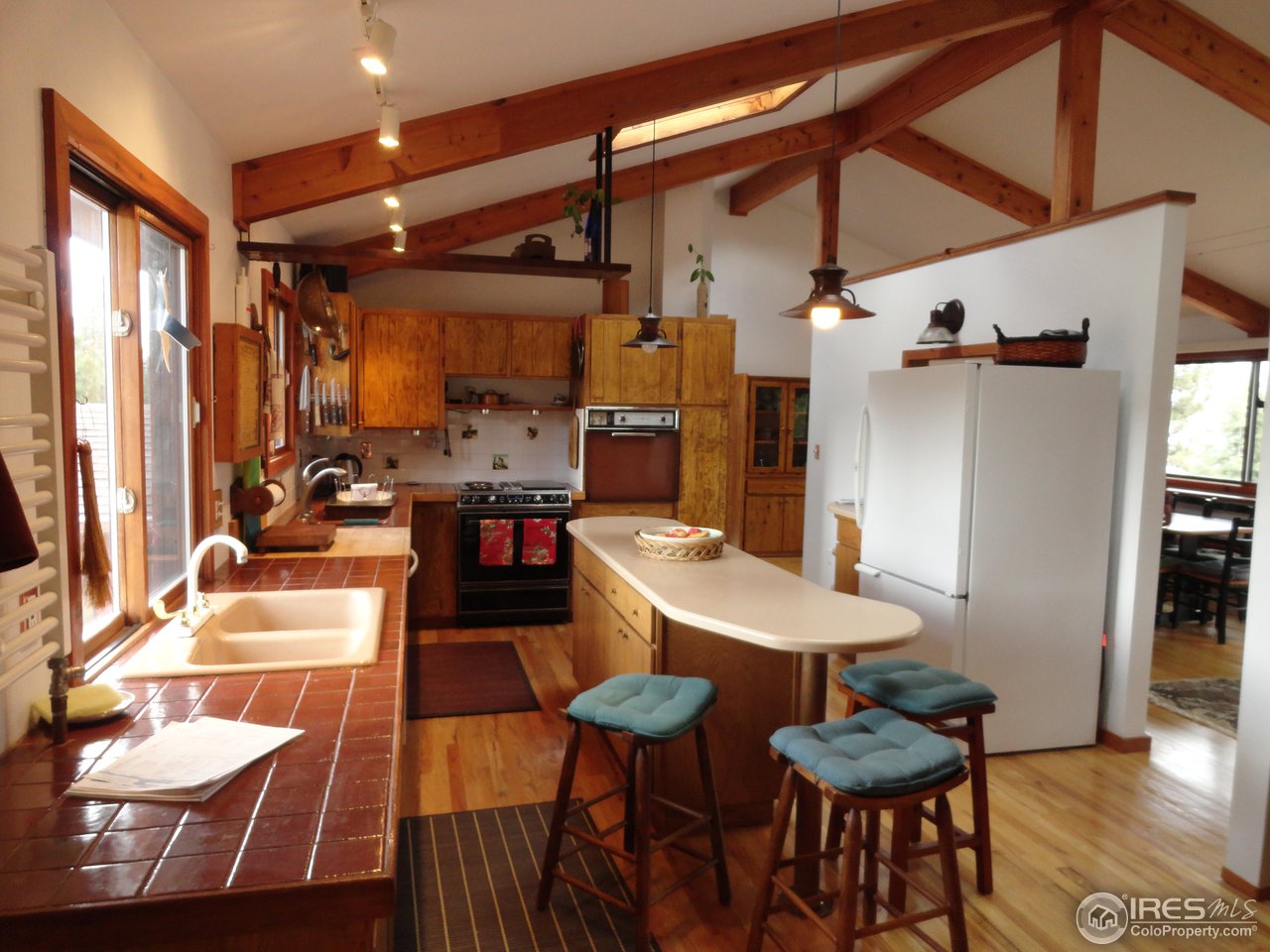 853 Deer Trail Road Boulder, CO 80302 - Photo 8 of 22 a view of a dining room with furniture and wooden floor