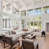 a living room with furniture fireplace and a large window