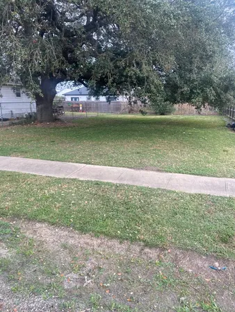 a view of a swimming pool with a yard