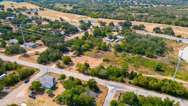 an aerial view of a house with a yard