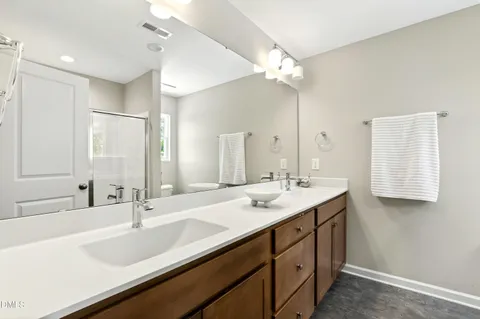 a bathroom with a glass shower door and a glass door